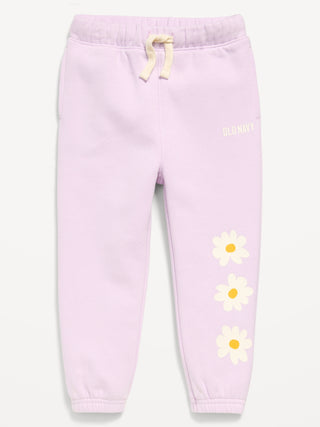 Pantalones deportivos estilo jogger con logo gráfico para niñas pequeñas.