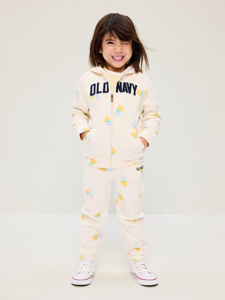 Pantalones deportivos tipo jogger con logo estampado para niñas pequeñas.